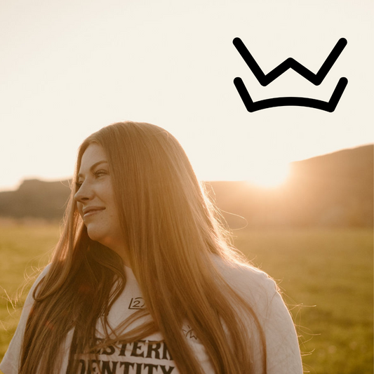 Photo of Kate Biaggi in a pasture with a W Over Crown Brand imposed on the image. 